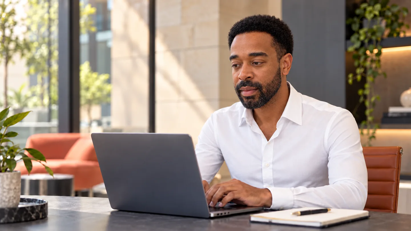 Jazz Parker working at a laptop.